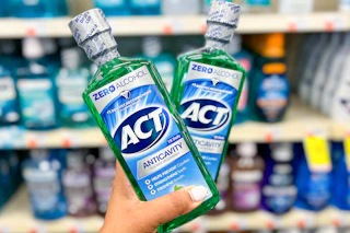 hand holding two bottles of act mouthwash