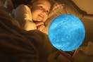 a girl near a moon lamp