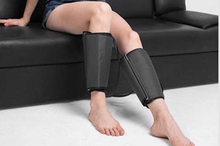 Woman using the  CINCOM Leg Massager for Circulation and Pain Relief, Air Compression on her couch.