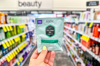 person holding a hair mask in an aisle
