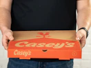 Someone holding a Casey's pizza box