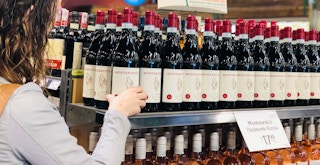 a person looking at wine in whole foods