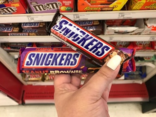 hand holding snickers candy bars at target