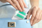 woman placing interdental brushes in to purse