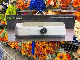 cricut maker machine on walmart cart in front of silk flowers