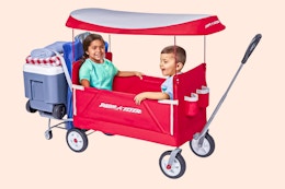Two children sitting in the Radio Flyer, 3-in-1 Tailgater Wagon