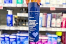 person holding a bottle of men's minoxidil hair growth
