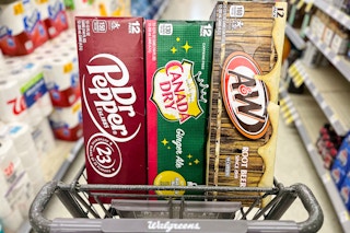 three 12-packs of soda in store aisle