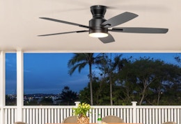 a ceiling fan on the roof of a patio 