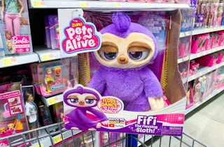 zuru pets alive fifi the flossing sloth robot toy sitting on walmart cart in front of other toys
