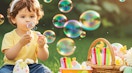 a kid blowing bubbles next to an basket full of bubble wands