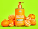 a bottle of hand wash next to tangerines 