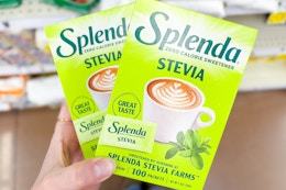 hand holding boxes of splenda sweetener