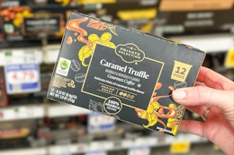 hand holding a box of private selection k-cups