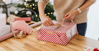 Photo by Karolina Grabowska | Pexels
 https://www.pexels.com/photo/woman-wrapping-gift-near-christmas-tree-5469249/