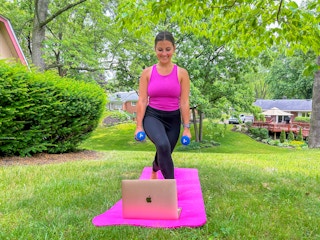 a person working out while looking at a macbook