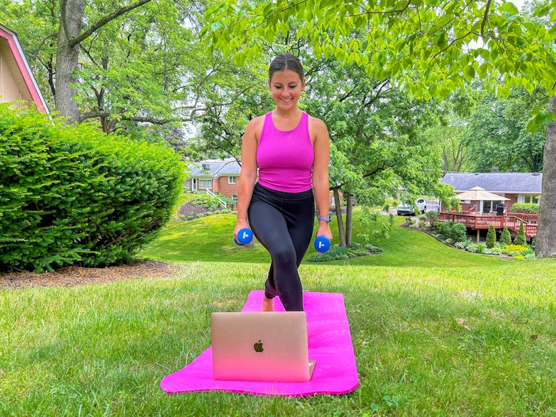 a person working out while looking at a macbook