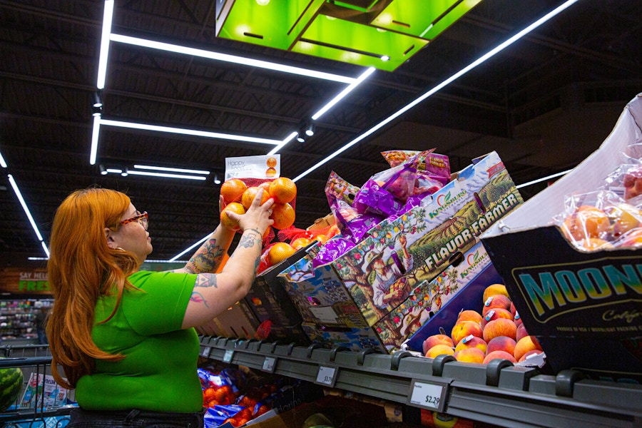 Person wearing a green top while grocery shopping inside an Aldi's