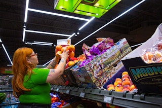 Person wearing a green top while grocery shopping inside an Aldi's