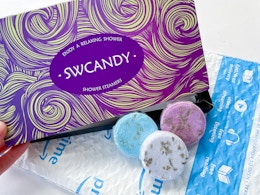 a purple box behind three shower steamers