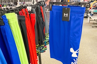 blue shorts held up by display rack of under armour shorts in store