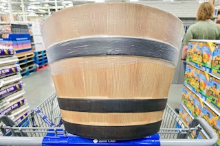 large wine barrel planter on a cart