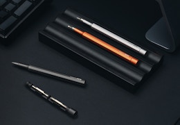 pocket screwdrivers in a holder on a black surface