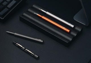 pocket screwdrivers in a holder on a black surface