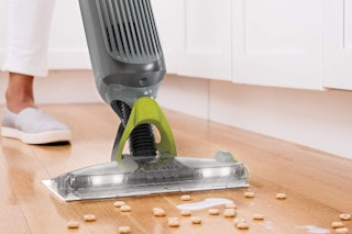 someone using the Shark Vacmop Pro to clean up a mess