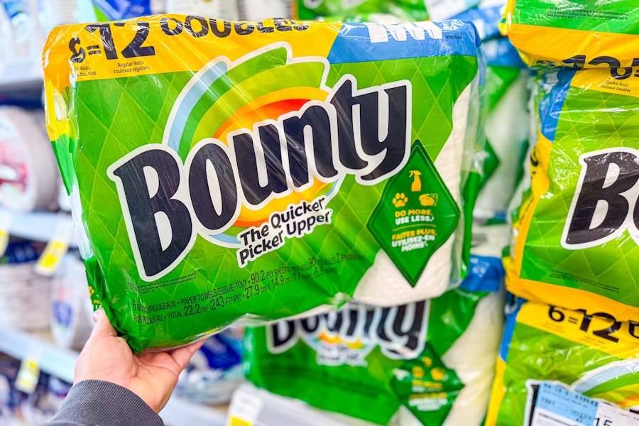 person grabbing a 6 pack of bounty paper towels