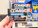 hand holding combat ant bait at dollar general
