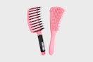 two hair brushes on a grey background