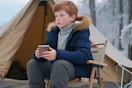 a boy wearing a puffer jacket