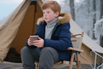 a boy wearing a puffer jacket