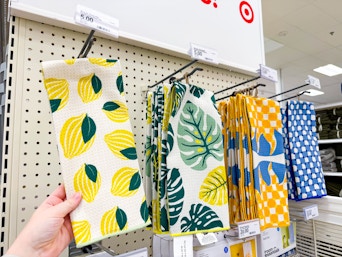 hand grabbing a hand towel off a target shelf
