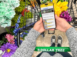 a person on their iphone looking at the krazy coupon app while in dollar tree