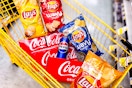 4 bags of lays, 3 coca cola 12-packs, and a can of pepsi in a cart