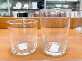 A Simply Essential 12-Piece Assorted Tumbler Set on a shelf at Bed Bath & Beyond.