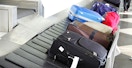 luggage going around baggage claim carousel in airport
