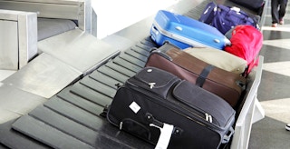 luggage going around baggage claim carousel in airport