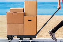 Lifestyle image of the FOUKUS Folding Hand Truck being used to pull stacked boxes