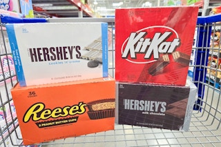 boxes of hersheys, reeses, and kit kat candy bars in a cart