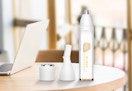 a nose and hair trimmer on a table with a laptop