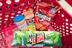 mountain dew soda, skippy peanut butter, dunkin coffee, doritos, and crayola crayons in a cart