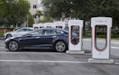 Two Tesla cars parked at a Tesla charging lot