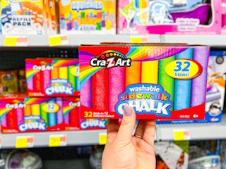 hand holding crazart sidewalk chalk in walmart aisle