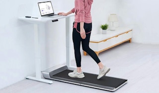 A person walking on a WalkingPad under-desk treadmill in their home office