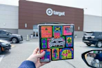 person holding a needoh halloween advent calendar in front of target