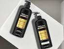 two black and gold pump bottles of shampoo and conditioner