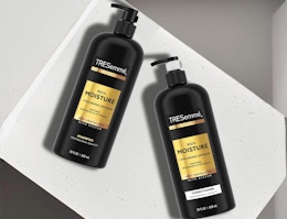 two black and gold pump bottles of shampoo and conditioner